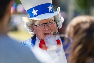 Rachel Thompson/News-Register##Emcee Zach Martin, dressed as Uncle Sam, chats with visitors during Saturday in the Park.
