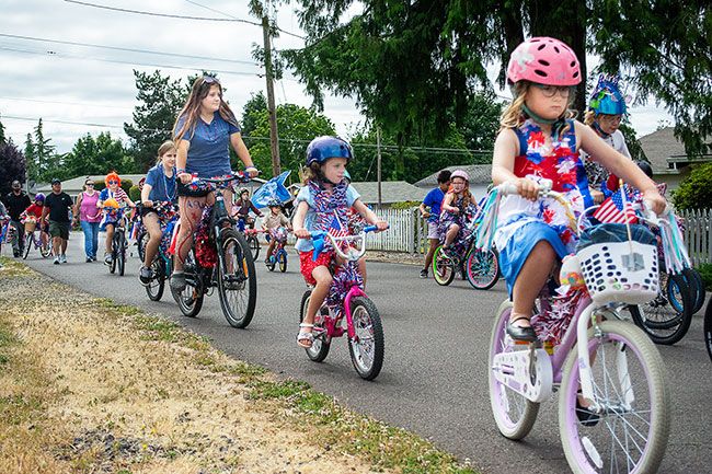 Ossie Bladine/News-Register##Dozens of Lafayette youths pedal along Seventh Street Saturday for the annual Fourth of July kids bike parade. The paraders gathered at Wascher Elementary School to decorate their bikes in patriotic colors, ribbons and more. The procession started at 10:30 and was led by new and vintage fire trucks and a Lightning McQueen vehicle &mdash; with Mayor Hilary Malcomson as a passenger. It ended at Joel Perkins Park where the rest of the day&rsquo;s community celebration was held.