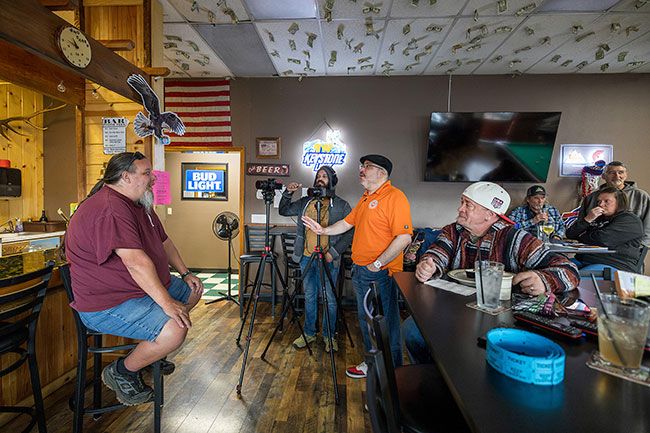 Rachel Thompson/News-Register##Rivera and Rodriguez talk through the next take with Coyote Joe&rsquo;s co-owner Chris Deprimo, left, in the restaurant&rsquo;s bar. Community members, including Willamina resident Iver Gustafson at right, filled the restaurant to support Coyote Joe&rsquo;s during the filming.