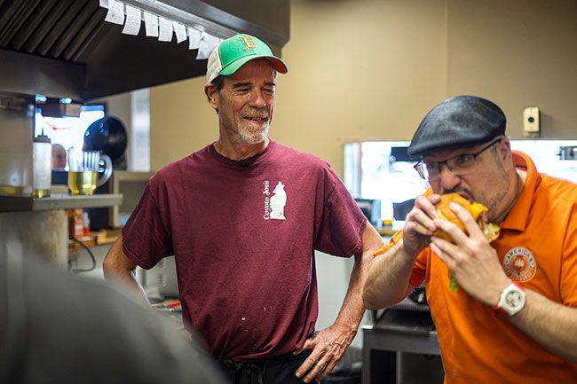 Rachel Thompson/News-Register##Coyote Joe&rsquo;s lead cook Darrel Tisdel, left, watches as &ldquo;America&rsquo;s Best Restaurants Roadshow&rdquo; host Luis Rivera samples the restaurant&rsquo;s signature Coyote Burger during filming. &ldquo;Wow,&rdquo; Rivera said. &ldquo;That&rsquo;s a really good burger.&rdquo; He continued eating after the segment ended, quipping to the kitchen crew, &ldquo;If I take more than one bite, you know it&rsquo;s good.&rdquo;