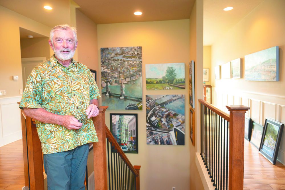 Rusty Rae/News-Register##Phil Juttelstad, surrounded by his paintings of buildings, bridges and cities, talks about how intentionally he has pursued his art since retiring from a career as a project manager. He and his wife, Holly, support the local art scene and are the founders of this weekend&rsquo;s McMinnville Art Festival, at which both will show work.