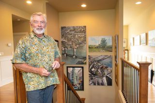Rusty Rae/News-Register##Phil Juttelstad, surrounded by his paintings of buildings, bridges and cities, talks about how intentionally he has pursued his art since retiring from a career as a project manager. He and his wife, Holly, support the local art scene and are the founders of this weekend&rsquo;s McMinnville Art Festival, at which both will show work.