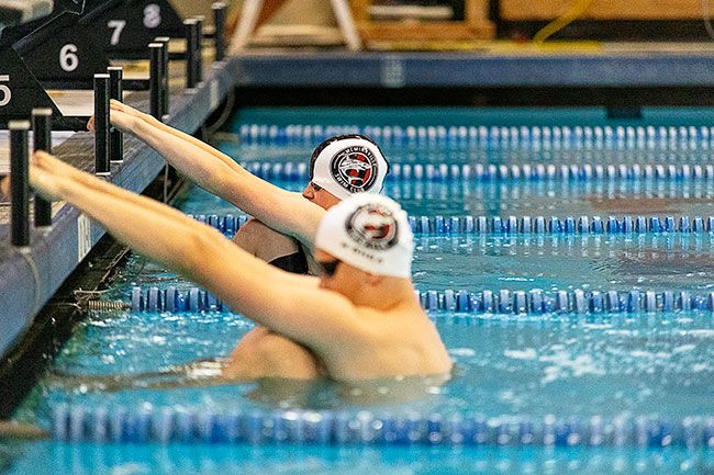 Nathan Ecker/News-Register##Keller Shea (foreground) and Isaac Chase (background) prepare to reverse swan dive into the water as opposing first legs of the boys’ 13-and-over 200-yard medley. Shea will be entering college in the fall, leaving the future of Mac swimming to aquatic athletes like Chase who have impressed the coaches. Nathan Ecker/News-Register##Keller Shea (foreground) and Isaac Chase (background) prepare to reverse swan dive into the water as opposing first legs of the boys’ 13-and-over 200-yard medley. Shea will be entering college in the fall, leaving the future of Mac swimming to aquatic athletes like Chase who have impressed the coaches.