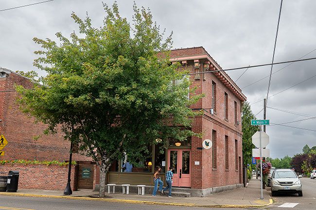 Rusty Rae/News-Register##The new shop is located in Carlton&rsquo;s century-old brick bank building downtown. In addition to the food and merchandise on the first floor, the business has a large patio in back and lodgings upstairs.