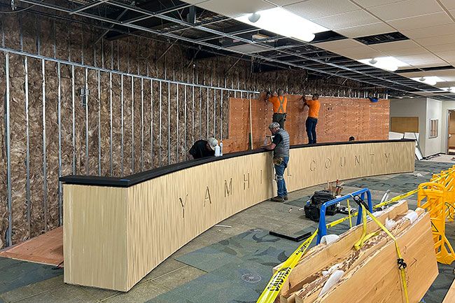 Kristi Boylan/Sera Architects##Haworth Inc. workers finish walls and work on the new board dais last week inside the Yamhill County Government Services Building.