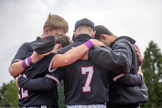 Nathan Ecker/News-Register##A group of McMinnville varsity baseball players takes time after their 1-0 victory over Sherwood on Friday, May 15 to say a prayer. It was also the same day that the Grizzlies raised money for the Mikalynn Jayde Morris Memorial Scholarship Fund, whom they kept in their thoughts.
