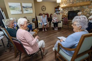 Rachel Thompson/News-Register##Mary Lou Coburn, left, shares a laugh with Mona Clark, right, during a rehearsal of the Vineyard Heights Theater Club. Across the room, director Carolyn McCloskey and Theresa Martsolf laugh along. The club will perform skits and routines July 31 at Vineyard Heights.