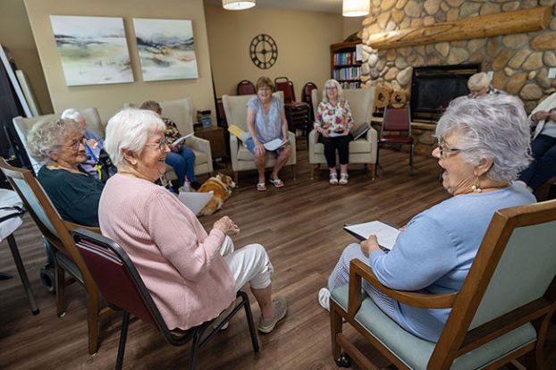 Rachel Thompson/News-Register##Mary Lou Coburn, left, shares a laugh with Mona Clark, right, during a rehearsal of the Vineyard Heights Theater Club. Across the room, director Carolyn McCloskey and Theresa Martsolf laugh along. The club will perform skits and routines July 31 at Vineyard Heights.