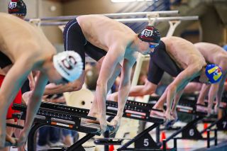 Rachel Thompson/News-Register##Keller Shea prepares to spring into the water to begin freestyle competition at the Pacific Conference District Meet on Saturday, February 14. For his final high school meet inside the McMinnville Aquatic Center, Shea led three relay teams to victory and claimed gold in the 100-yard freestyle. He was also named the conference Swimmer of the Year.