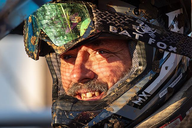 Rachel Thompson/News-Register##Helmet fastened and goggles flecked with mud, Will Tester of Sheridan waits to enter the arena for another round of competition.