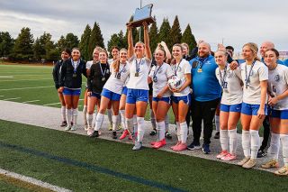 Rachel Thompson/News-Register file photo##Eliza Nisly raises the Warriors&rsquo; title trophy alongside Northrop and a group of teammates whose connection was so strong that it made her balk at the thought of playing soccer with anyone else.