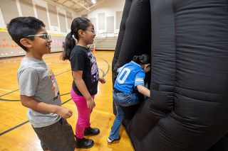 Rachel Thompson/News-Register##Third-graders Jose Diaz Cabanas, Alexandra Gil Villareal and Leah Ordaz excitedly enter the Carlton Observatory planetarium, set up in the gym at Grandhaven Elementary School. The planetarium visit was one of the enrichment activities offered during summer school, which also included P.E., art and large doses of math and language arts.