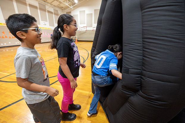 Rachel Thompson/News-Register##Third-graders Jose Diaz Cabanas, Alexandra Gil Villareal and Leah Ordaz excitedly enter the Carlton Observatory planetarium, set up in the gym at Grandhaven Elementary School. The planetarium visit was one of the enrichment activities offered during summer school, which also included P.E., art and large doses of math and language arts.