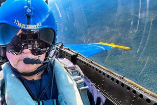 ##MFD Chief Reed Godfrey takes a selfie from the cockpit of the Blue Angels Super Hornet jet. The extensive straps and harnesses connecting him to an ejector seat made movement a challenge in an already tight space, according to Godfrey.
