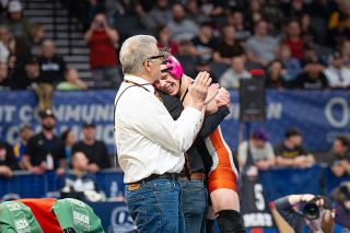 Rusty Rae/News-Register file photo##Willamina alumnus Kisor Savage jumps into the arms of his high school head coach, Ariah Fasana, and gets the applause of assistant Barry Wilson after claiming the Class 3A 138-pound title at Veterans Memorial Coliseum in Portland on Feb. 28. It was Savage&rsquo;s first time as a high school champion after reaching the final four in each of his first three seasons.
