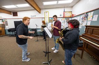 Rachel Thompson/News-Register##Ryan Lewis, Willamina performing arts director, keeps saxophone players Mason Baller, a sophomore, and Aurora Robinson, a freshman, on tempo as they play &ldquo;In the Mood&rdquo; by Glenn Miller. In the background, sophomore trumpet player Laurence McGivney works on another piece of music.