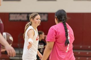 Nathan Ecker/News-Register## Maddie Miguez high fives a teammate for making a play in practice. Miguez wants to be a leader this season and is beginning by helping bring along underclassmen with words of encouragement. Coaches believe her steadiness will help the Pirates stay composed on the floor.