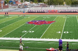 Nathan Ecker/News-Register##Linfield&rsquo;s primary Wildcat logo, created by Angelus Pacific Company&rsquo;s Head Artist Arthur &ldquo;Art&rdquo; Evans, is the new prominent image sitting at Maxwell Field&rsquo;s 50-yard line. Evans worked for Angelus Pacific from 1932-1977, where a large majority of college athletic programs enlisted their services, thus marking the prominence of the sailor hat mascot emblem.