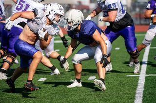 Nathan Ecker/News-Register##Senior Jackson Pfeifer finds a hole through the middle of the field as the Wildcats practice at Maxwell Field on Tuesday, Aug. 18. Pfeifer aided the offense on the ground and in the flats in 2025, rushing for 193 yards and tallying 187 receiving yards.