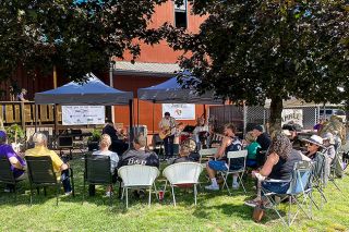 Starla Pointer/News-Register##Yamhill residents gather on the lawn behind the Larson House to listen to Thom Lyons and other performers Saturday during the first Jamhill festival. Jamhill was an effort to promote local music and businesses, Yamhill Downtown Association members said, along with supporting Yamhill Carlton school music programs.