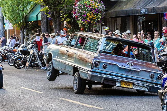 Rachel Thompson/The News-Register##Hydraulics lift a lowrider station wagon into a three-wheel stance, drawing cheers from spectators during Saturday evening&rsquo;s cruise event.