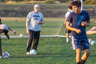 Nathan Ecker/News-Register##Andy Dyer watches from the middle of a Warrior boys&rsquo; practice on Tuesday, Aug. 18. Making sure players are developed with the skills to be competitive is the first step in the program s growth.