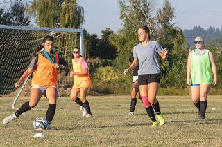 Nathan Ecker/News-Register##YC freshman Abigail Wheeler closes out on senior captain Arlette Vilorio during a &ldquo;keep away&rdquo; drill at Tigers&rsquo; practice on Monday, Aug. 24.