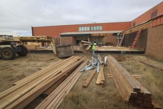 Rachel Thompson/News-Register##Willamina School District spent the summer improving facilities as part of its $5 million school bond project. Here, a construction crew works on the forthcoming culinary arts lab, which is in a courtyard between the high school shop and the rear of the main building.