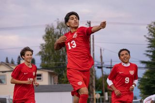 Nathan Ecker/News-Register##McMinnville senior midfielder Edwin &ldquo;Isai&rdquo; Cuevas George, flanked by junior Luke Corrigan (left) and freshman Thiago Rangel (right), unleashes his signature celebration toward the grandstand at Wortman Stadium following his second goal against Silverton on Tuesday, Sept. 1. Isai scored Mac&rsquo;s first three goals in the season opening 5-2 victory.