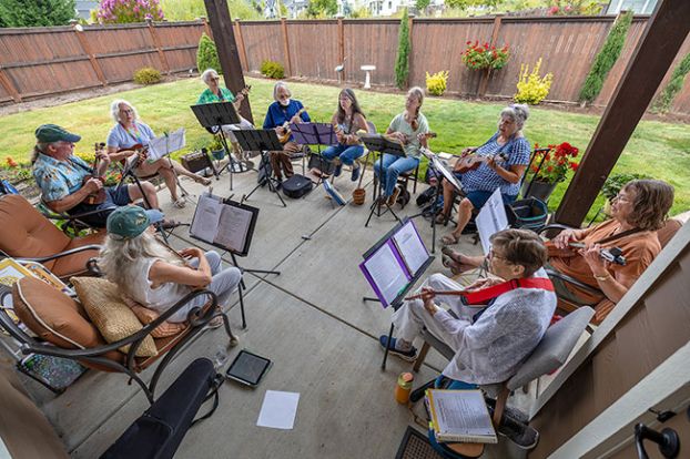 Rachel Thompson/News-Register##Ten members of the Maculeles, bonded by a love of a small stringed instrument, strum their ukuleles at a practice session in August. They&rsquo;ve been playing warm-weather songs, such as &ldquo;Summertime Blues&rdquo; and &ldquo;Summer Holiday.&rdquo;