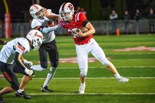 Rusty Rae/News-Register##Sophomore running back Patton Greene stiff arms Beaverton senior 	Gabe Tawiah. Greene ran with power, making him a tough back to bring down.