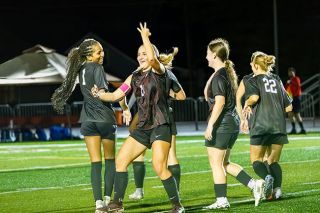 Nathan Ecker/News-Register##Senior Tessa Ravia flashes three fingers to the home crowd in celebration of her home opener hat trick. All of her goals were scored from 20-plus yards out as she decided to go above rather than through McNary&rsquo;s defense.