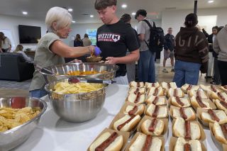Starla Pointer/News-Register##
Sandy Ransom hands out chips to Caleb Gray, a McMinnville High School sophomore, during lunch in the newly expanded Young Life center. Summer construction more than doubled the size of the building, where students can gather for free lunch on Wednesdays or relaxation and social time before and after school. Michael Rilee, the director, said the Christian program is open to all.