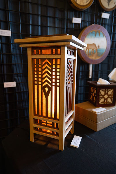 Rachel Thompson/News-Register##A maple and mahogany table lamp by Newberg artist Ken Trox features a geometric design inspired by Frank Lloyd Wright. Trox&rsquo;s display ranged from lighting to custom cribbage boards, tissue box covers and other woodwork.