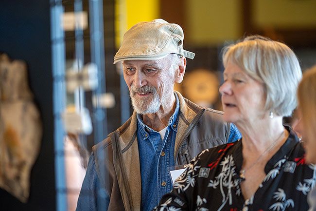 Rachel Thompson/News-Register##Kenn Conger and Laurie McCollum of McMinnville browse artwork on display during the reception. The exhibit continues until Sept. 27. Hours are 11 a.m. to 5 p.m. Fridays through Sundays.
