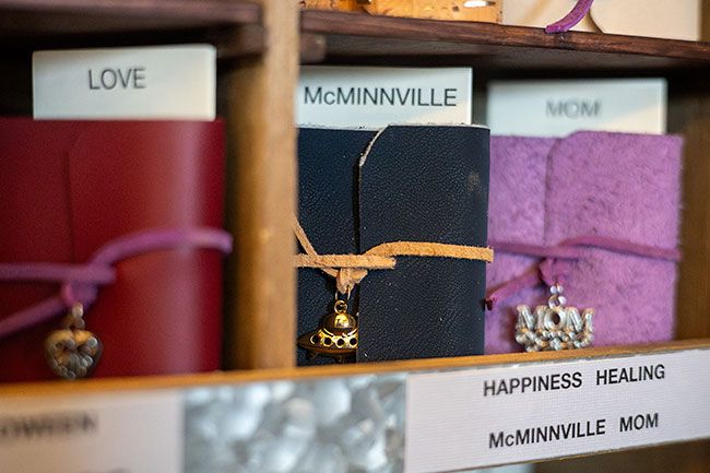 Rachel Thompson/News-Register##Hand-stitched miniature books by Penny Tucker of Dundee cover a wide range of subjects. Tucker fills the pages with quotes, sayings and her own photographs related to each theme.