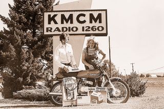 ##Winner In KMCM&rsquo;s Summer Bonanza was Suzanne Singer, 21, of McMinnville. Suzanne won a new motorcycle and other merchandise by finding a hidden motorcycle key on a telephone pole halfway between Newberg and McMinnville. Presenting the prizes is KMCM disc jockey Bernie Craig.