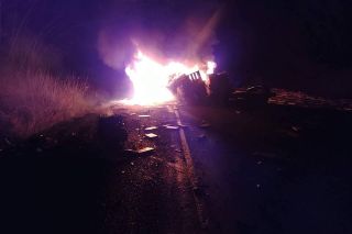Photo by Scott Edwards##A vehicle erupted in flames Friday morning following a motor vehicle crash on Highway 18, east of Lafayette Avenue.