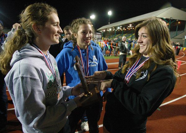Rockne Roll/News-Register##From left to right: Amity senior Meghan Drader, sophomore Amy Kraemer and senior Lindsay McShane celebrate the Warriors  third-place finish at the OSAA Class 3A State Track and Field Championships Friday night. The three Warriors combined to score all 56 of Amity s points in girls  events.
