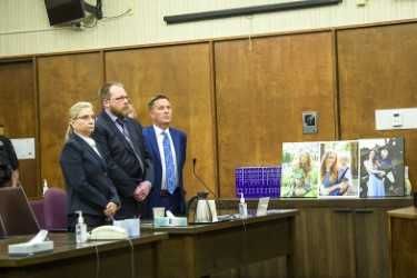 Rusty Rae/News-Register##Defense attorneys Diana Gentry, left, and Patrick Sweeney flank double-murderer Michael Wolfe at the defendant s sentencing hearing Wednesday moring in Yanhill County Circuit Court. Three photos of victims Karissa and Billy Fretwell are displayed to the right.