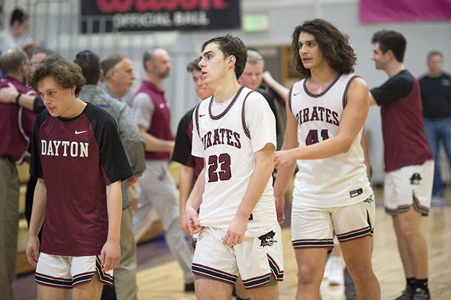 Marcus Larson/News-Register##
Dayton s boys basketball players walk off the court following their upset loss to Cascade Christian in the state quarterfinals.