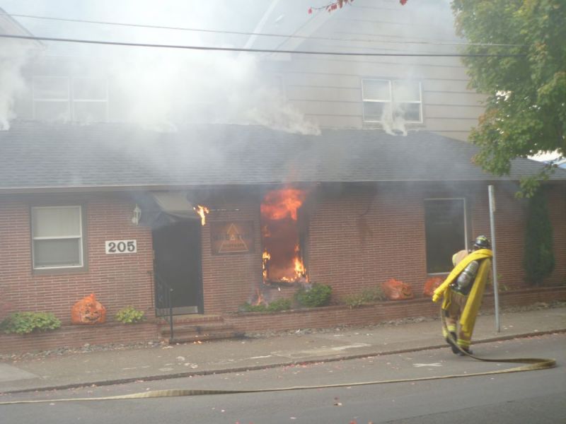 Paul Daquilante  / News-Register##Firefighters attack a blaze Tuesday morning at 205 N.E. Ford St., A Corgi was rescued, much to the residents  relief.