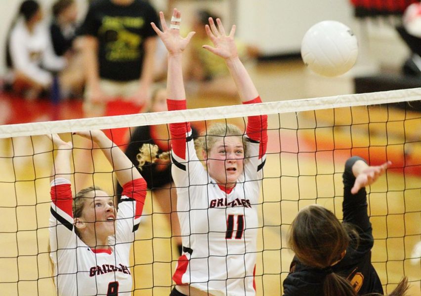 Rockne Roll/News-Register##
Aryc Kloninger (8) and Kalina Buhler (11) rise up for a block attempt during McMinnville s 3-1 win against Forest Grove.