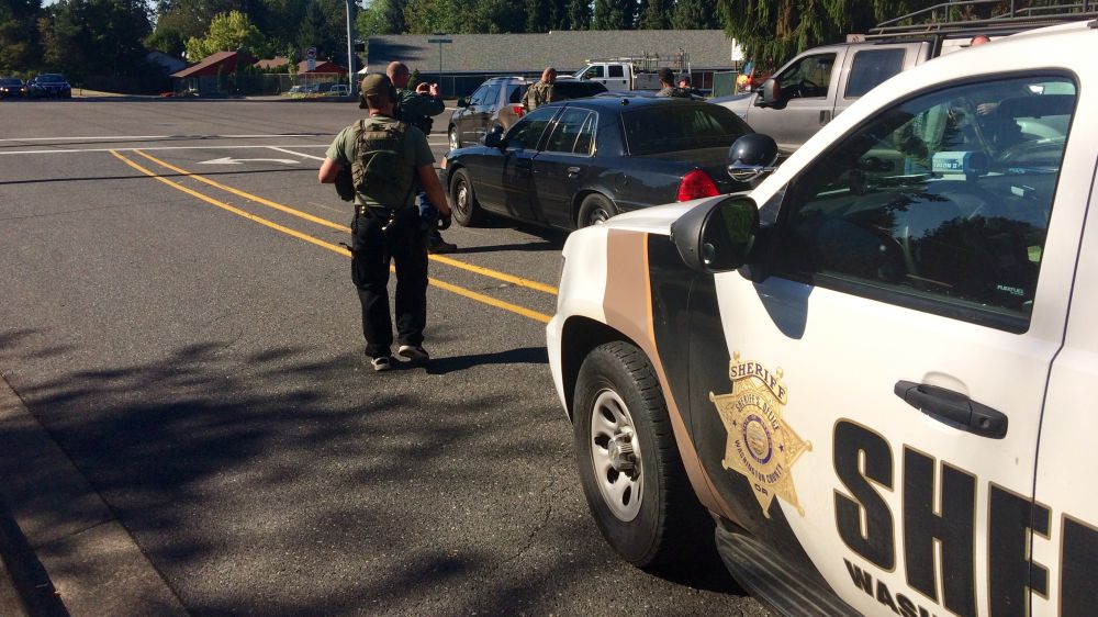 Photo courtesy Washington County Sheriff s Office##Deputies converge upon a vehicle Thursday containing North Plains murder suspect Christopher Stephens of Newberg.