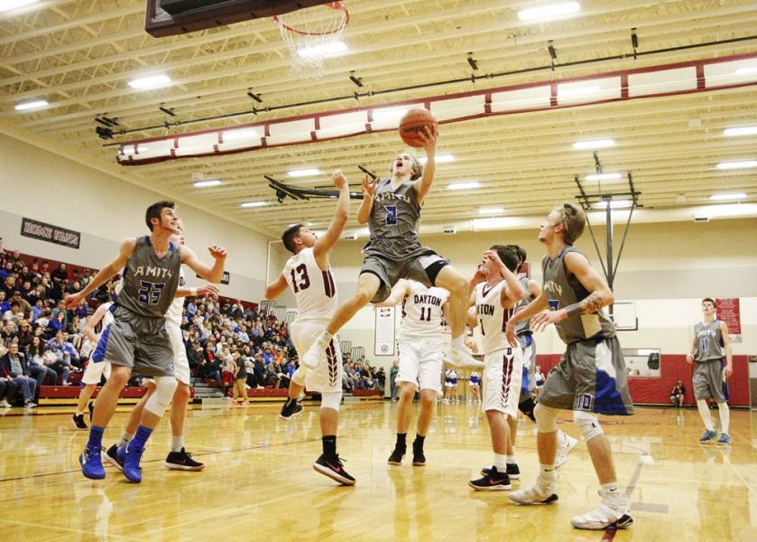 Rockne Roll/News-Register##
Amity s Sam White flies in for a coast-to-coast finish during the Warriors  66-60 loss to Dayton.