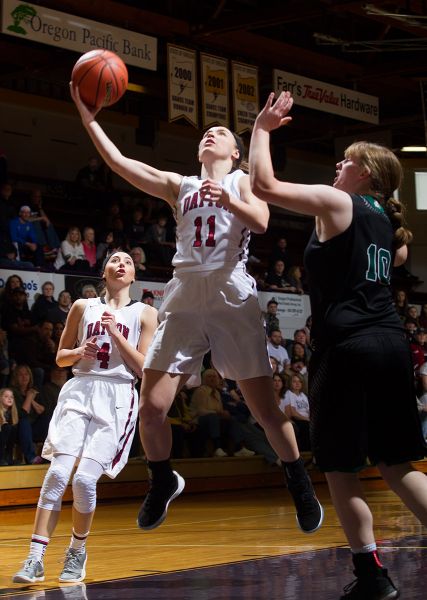 Rockne Roll/News-Register##
Shawnie Spink flies in for a lay-in against the Columbians.