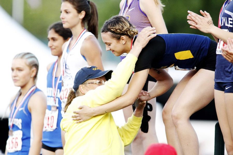 Rockne Roll/News-Register##
Sheridan s Ronni VanZant receives her 200m championship from her head coach, Barb Justen.