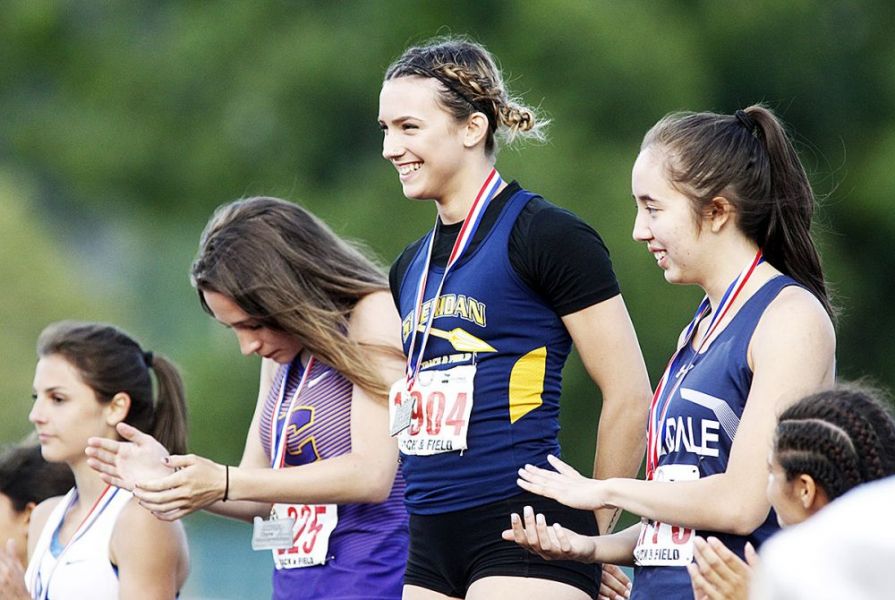 Rockne Roll/News-Register##
Sheridan s Ronni VanZant poses with her third state title - the girls  200m championship.