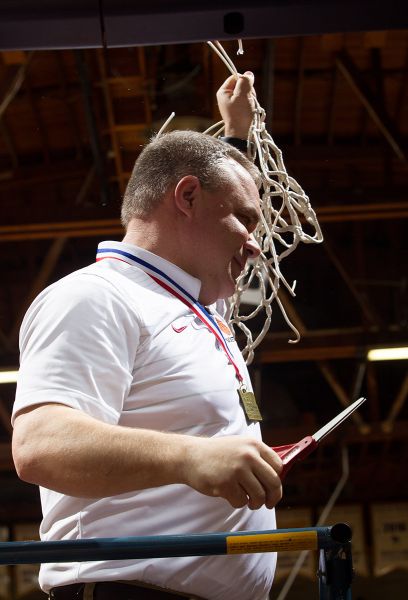 Rockne Roll/News-Register##
Dayton head coach Scott Spink cuts down the netting after his team won the championship.
