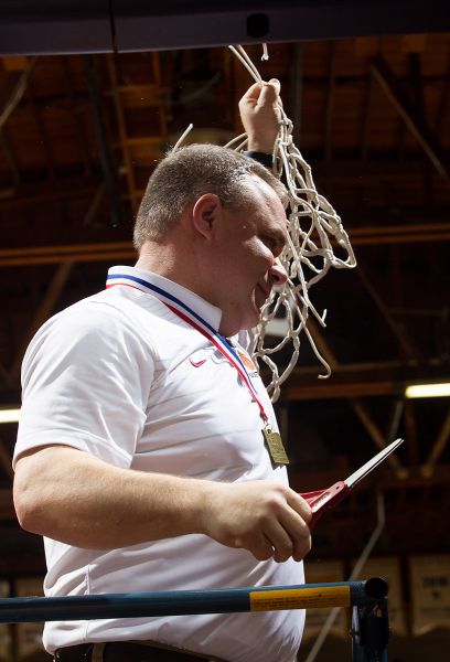 Rockne Roll/News-Register##
Dayton head coach Scott Spink cuts down the netting after his team won the championship.